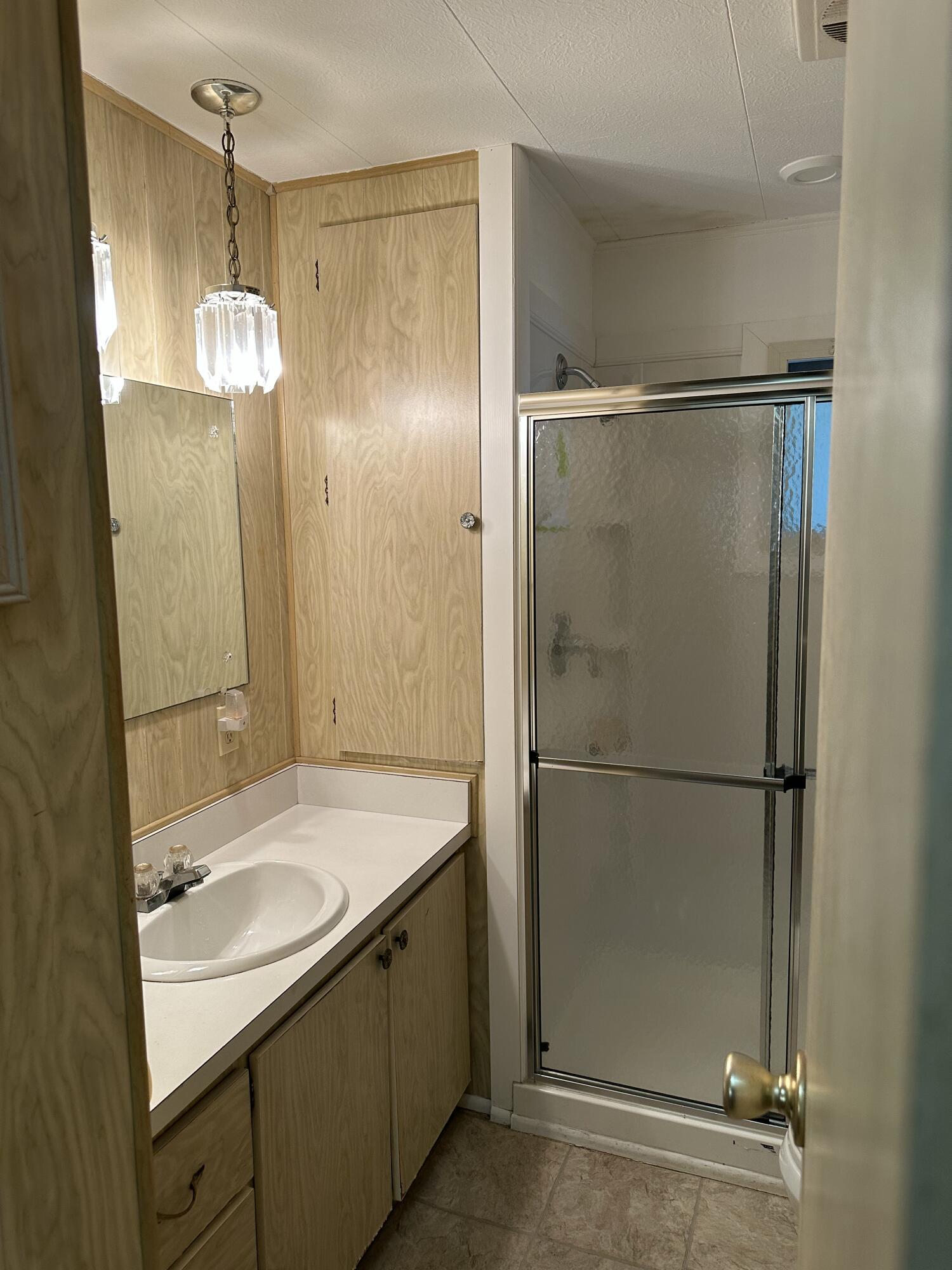 8435 East Club Road Boca Raton, FL 33433 - Photo 23 of 31 a bathroom with a sink mirror and a shower