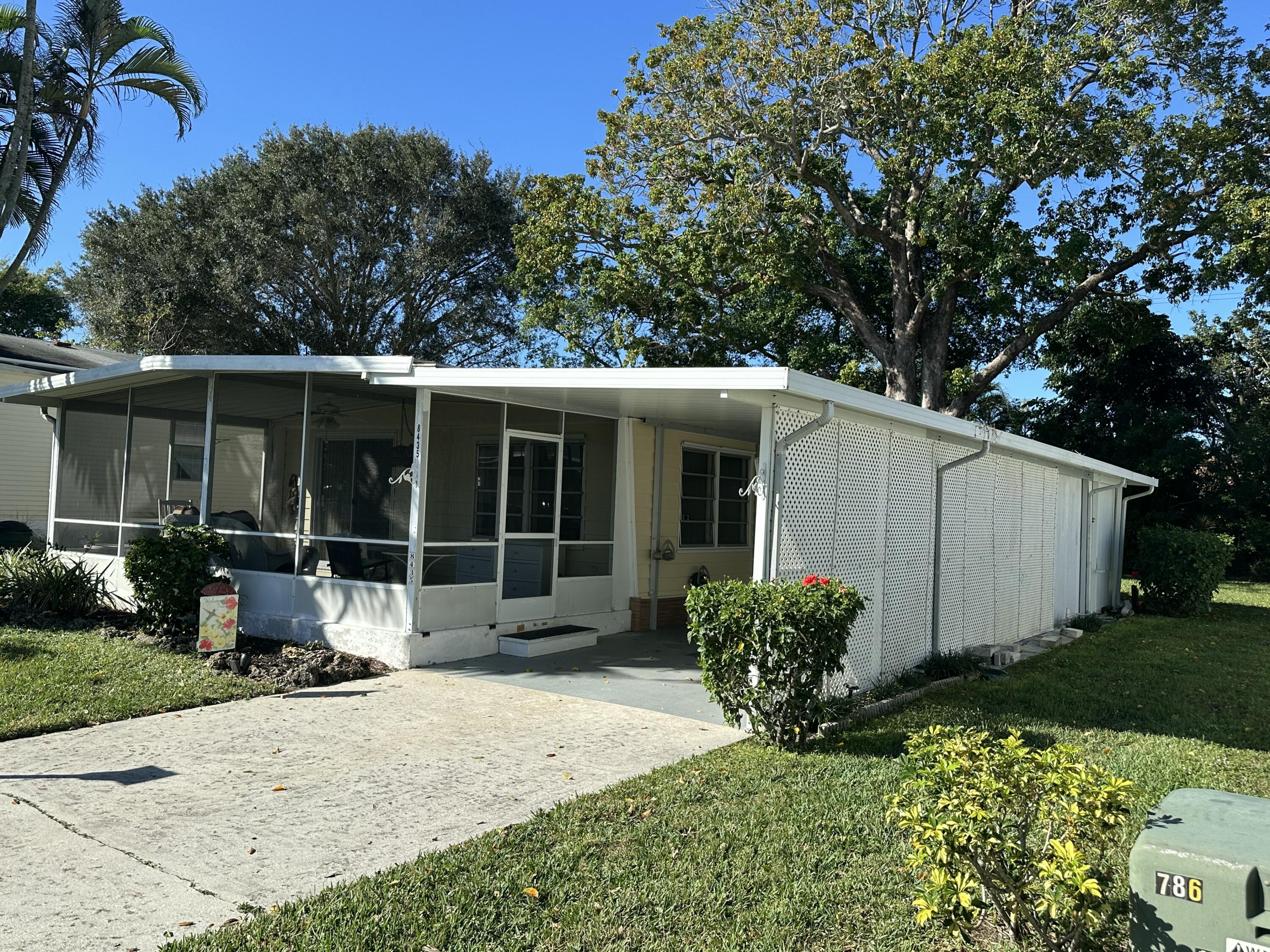 8435 East Club Road Boca Raton, FL 33433 - Photo 4 of 31 a view of a house with backyard and garden