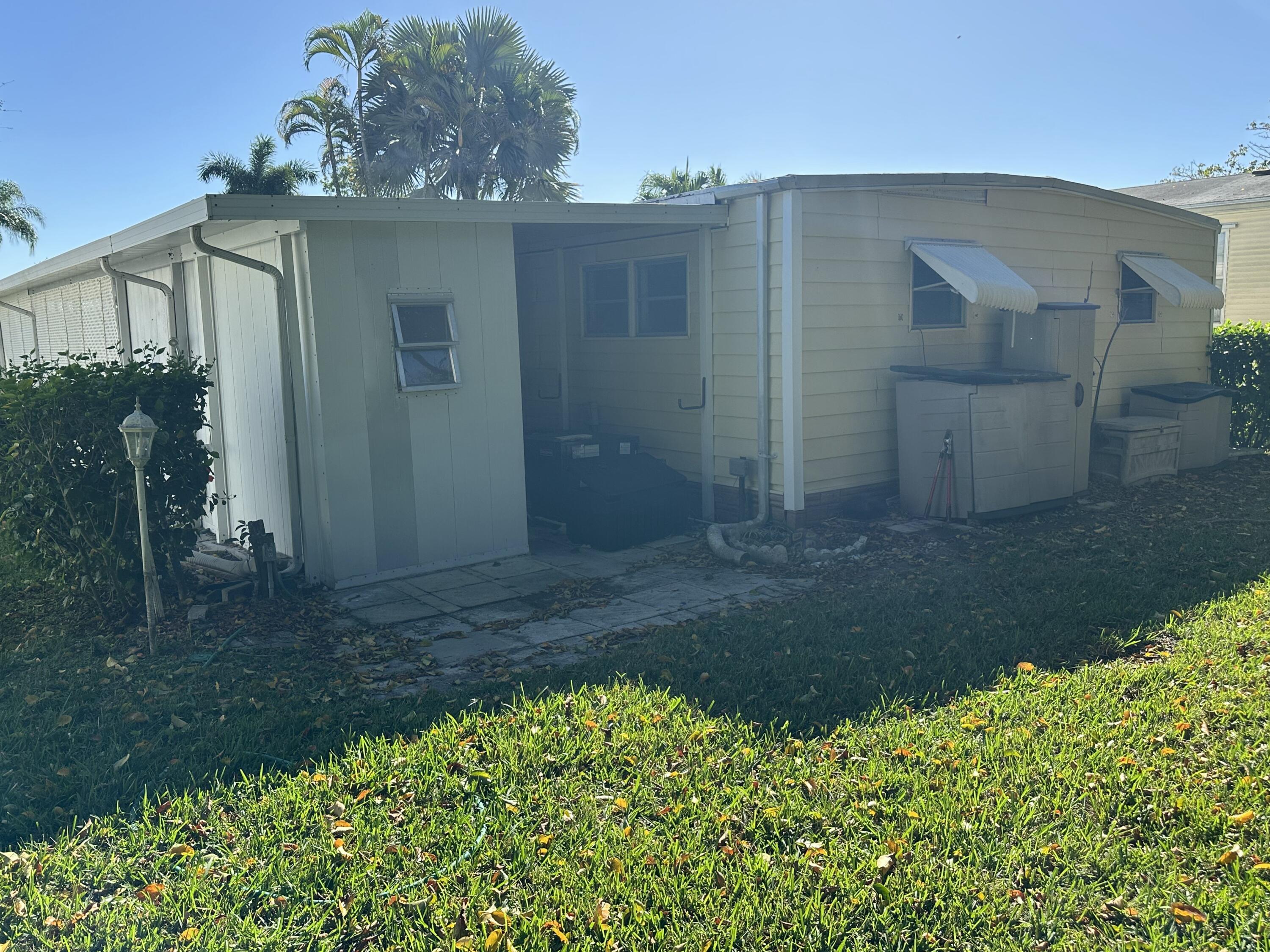 8435 East Club Road Boca Raton, FL 33433 - Photo 5 of 31 a view of a house with a yard