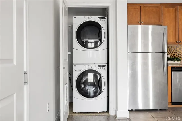 a kitchen with stainless steel appliances granite countertop a refrigerator sink and stove