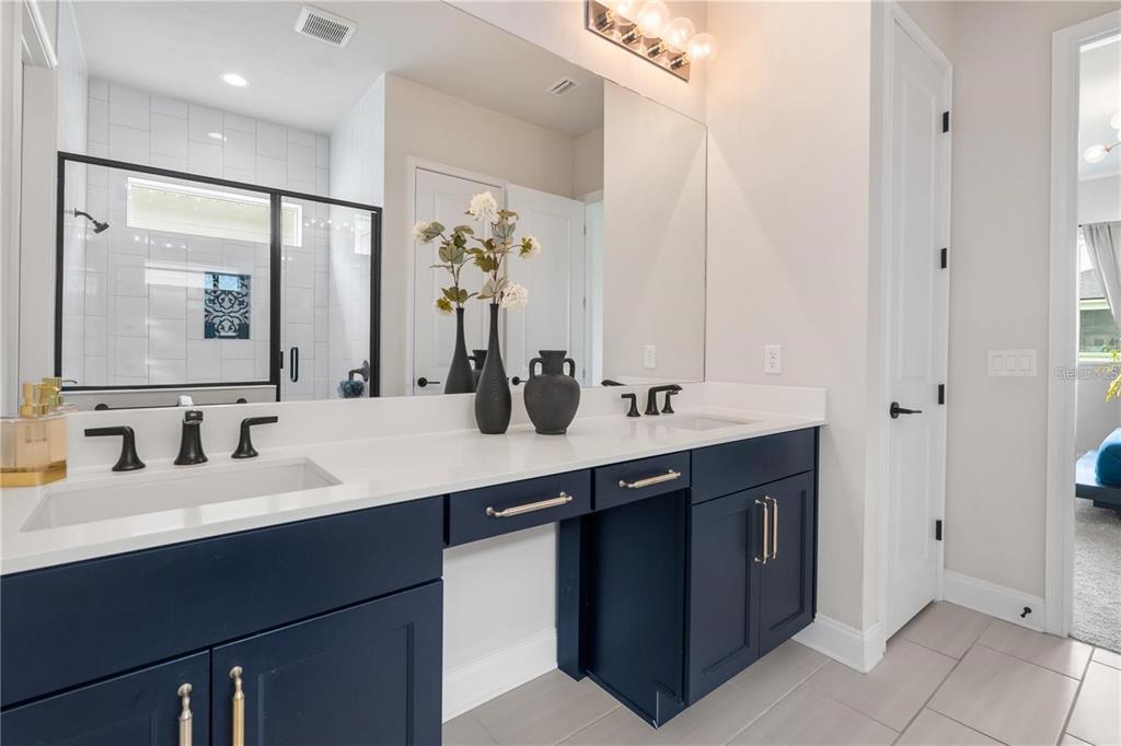 3225 Southwest 120th Terrace Gainesville, FL 32608 - Photo 14 of 42 a bathroom with a double vanity sink and a mirror