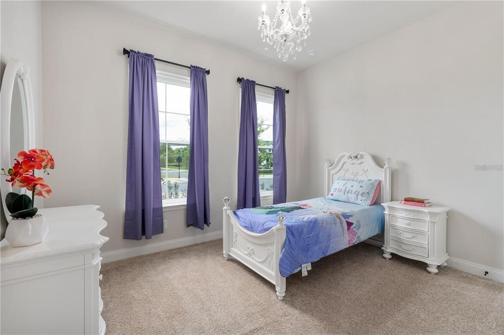 3225 Southwest 120th Terrace Gainesville, FL 32608 - Photo 18 of 42 a bedroom with a bed and a chandelier