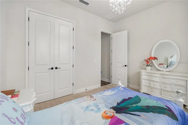 a bedroom with a bed and a dresser in it