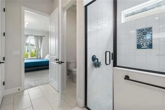 a view of a hallway with a livingroom and a bathroom