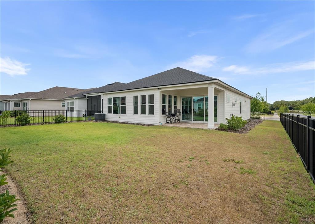 3225 Southwest 120th Terrace Gainesville, FL 32608 - Photo 29 of 42 a front view of a house with a yard table and chairs