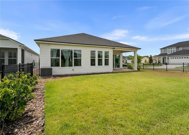 a view of a house with swimming pool and sitting area