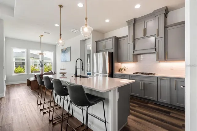 a large kitchen with a table and chairs