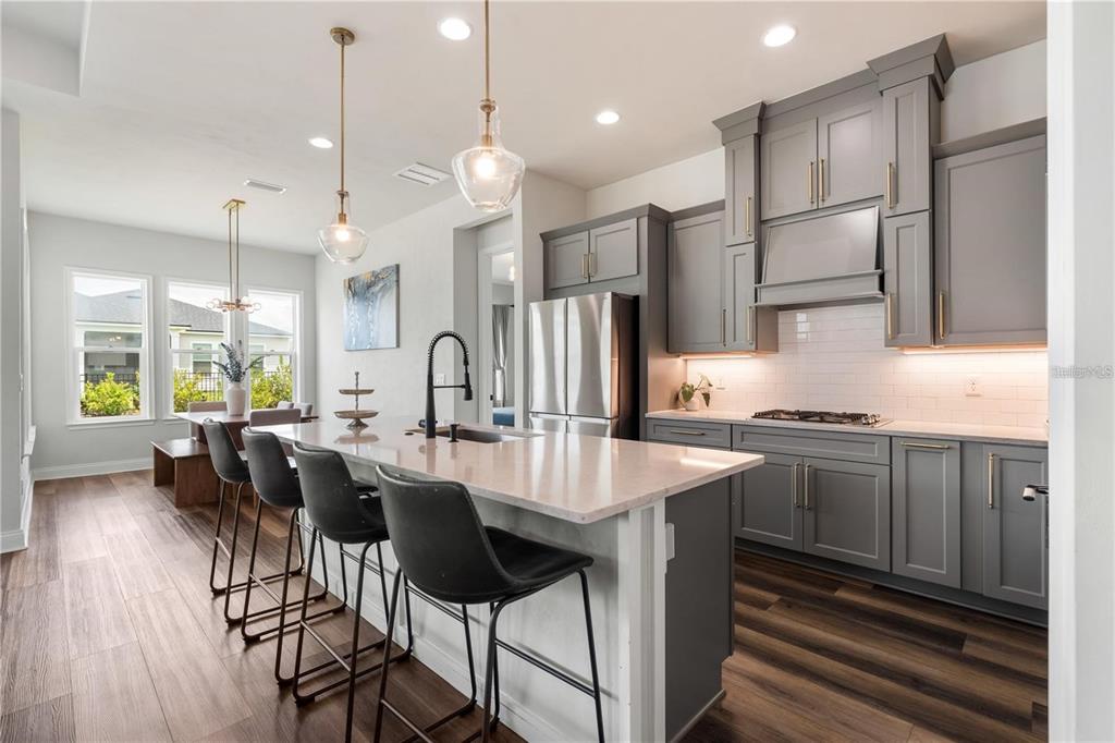 3225 Southwest 120th Terrace Gainesville, FL 32608 - Photo 3 of 42 a large kitchen with a table and chairs