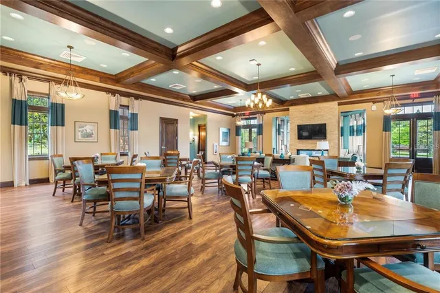 a view of a dining room with lots of furniture and wooden floor