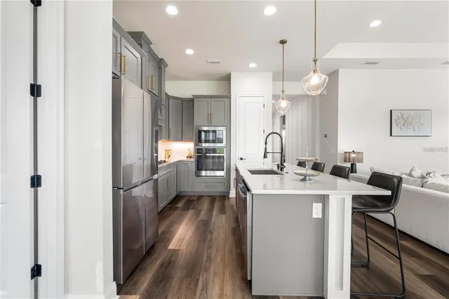 a kitchen with kitchen island a sink stove and refrigerator