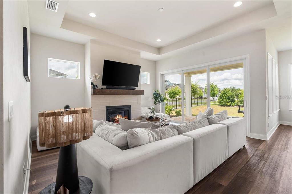 3225 Southwest 120th Terrace Gainesville, FL 32608 - Photo 8 of 42 a living room with furniture fireplace and a flat screen tv
