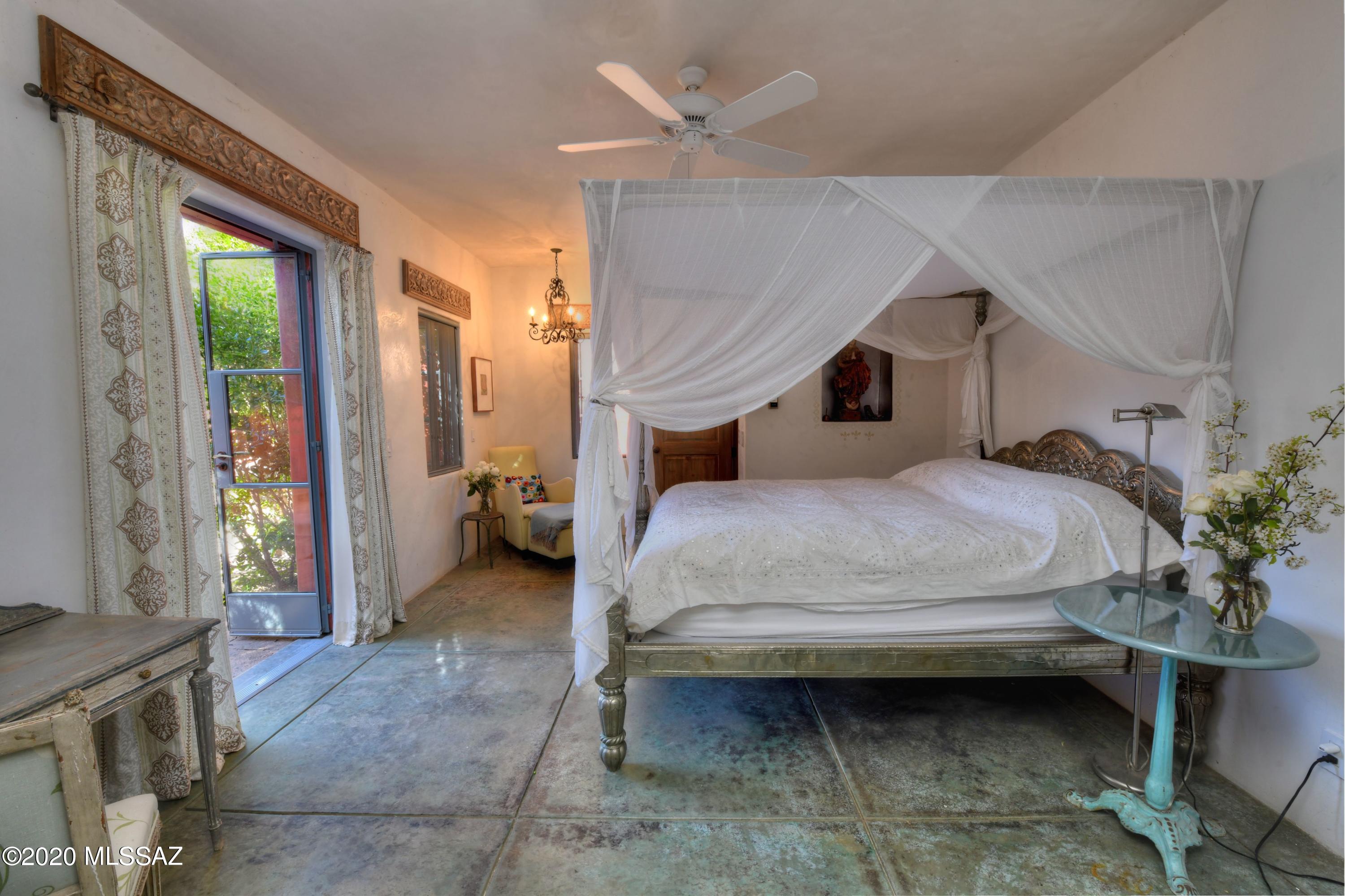 360 Harshaw Creek Road Patagonia, AZ 85624 - Photo 26 of 50 a bedroom with a bed and a large window
