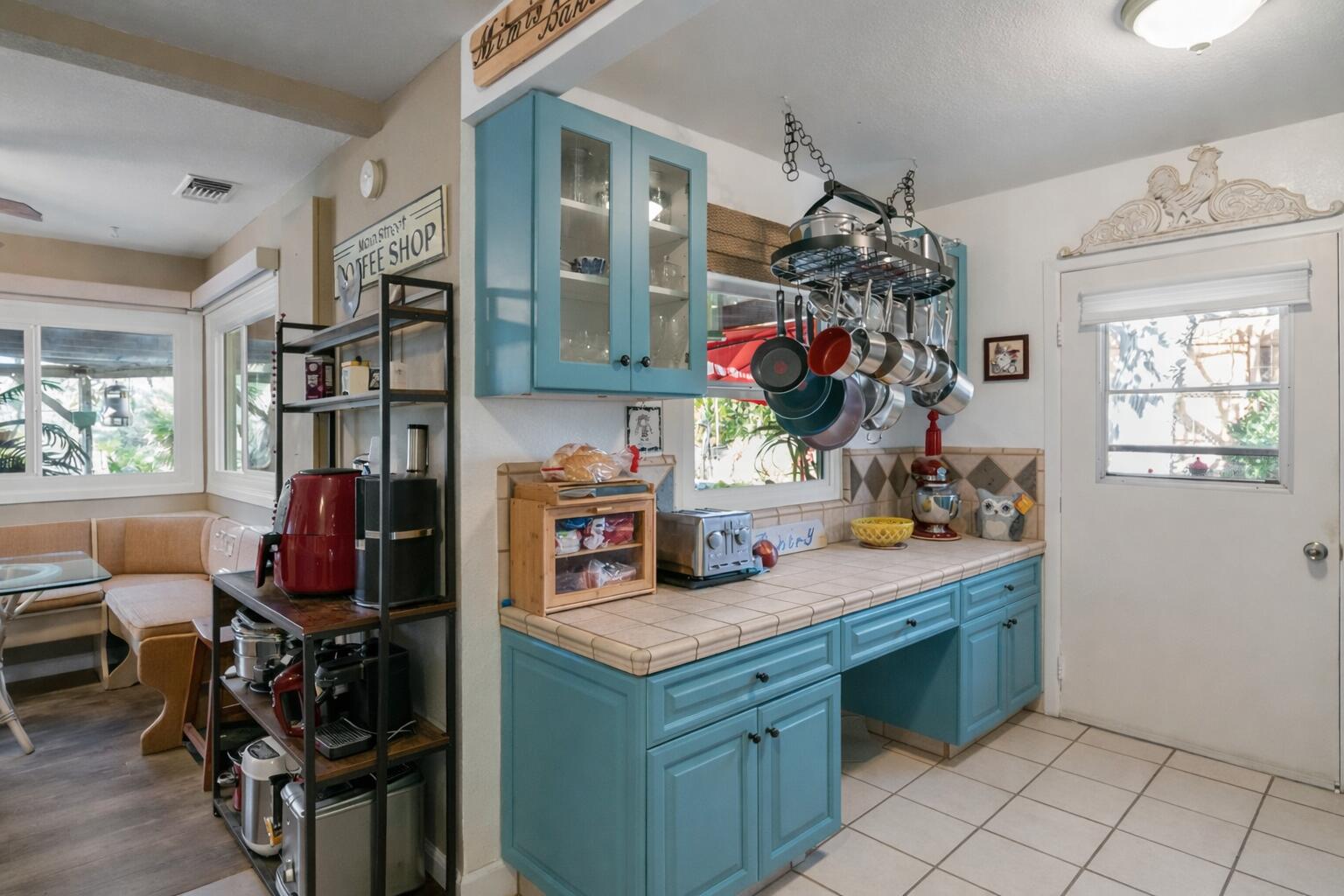 6913 Apache Trail Yucca Valley, CA 92284 - Photo 11 of 45 a kitchen that has a lot of cabinets and wooden floor