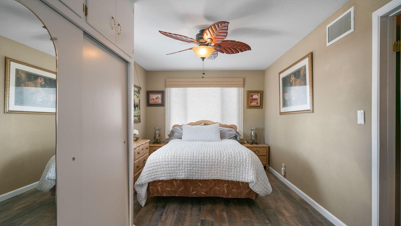 6913 Apache Trail Yucca Valley, CA 92284 - Photo 14 of 45 a bedroom with a bed and wooden floor