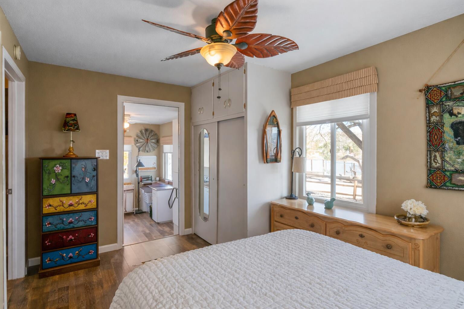 6913 Apache Trail Yucca Valley, CA 92284 - Photo 15 of 45 a bedroom with a bed and a chandelier