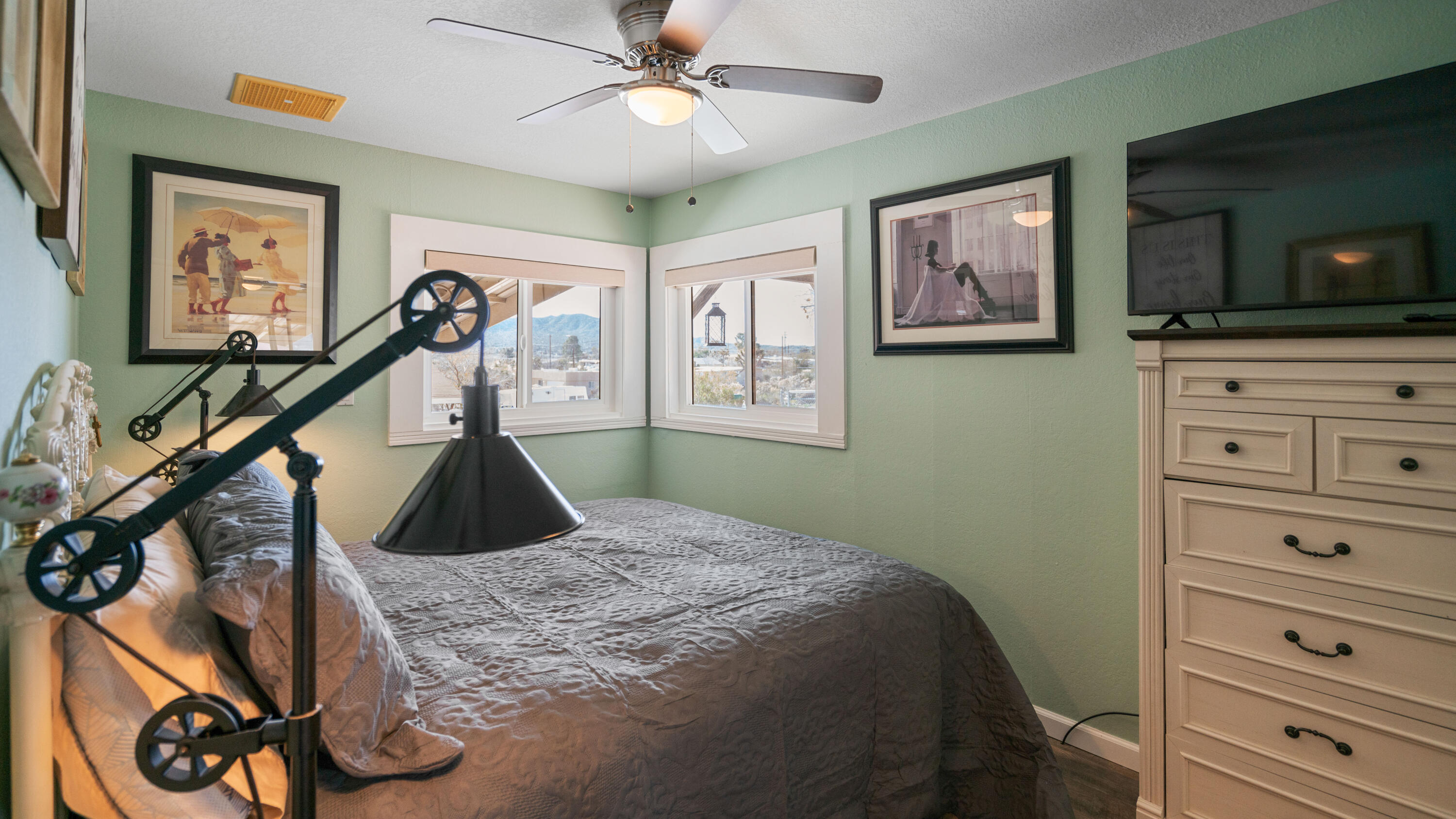 6913 Apache Trail Yucca Valley, CA 92284 - Photo 19 of 45 a bedroom with a bed and a flat screen tv