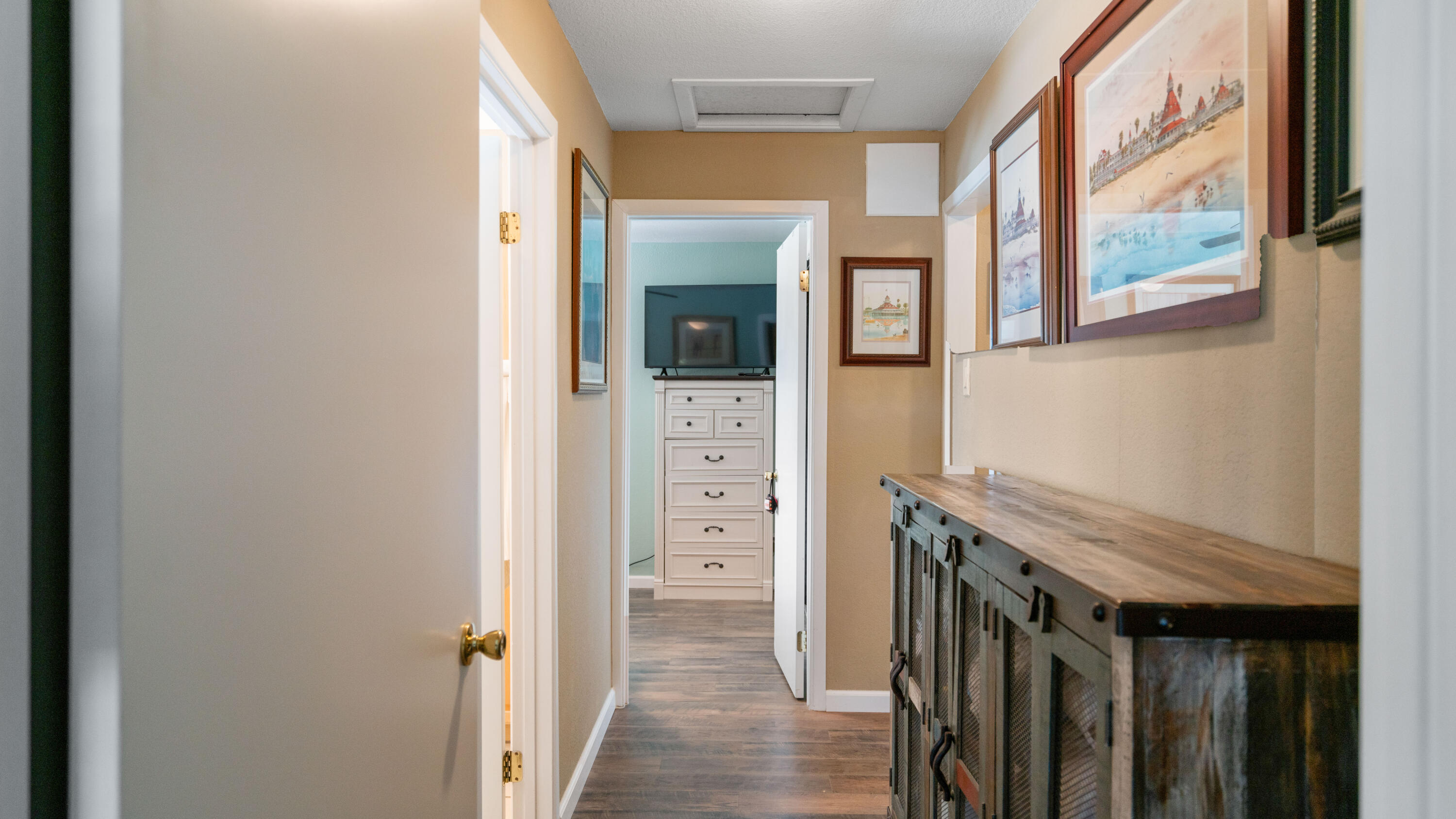 6913 Apache Trail Yucca Valley, CA 92284 - Photo 23 of 45 a view of a hallway with paintings on the wall