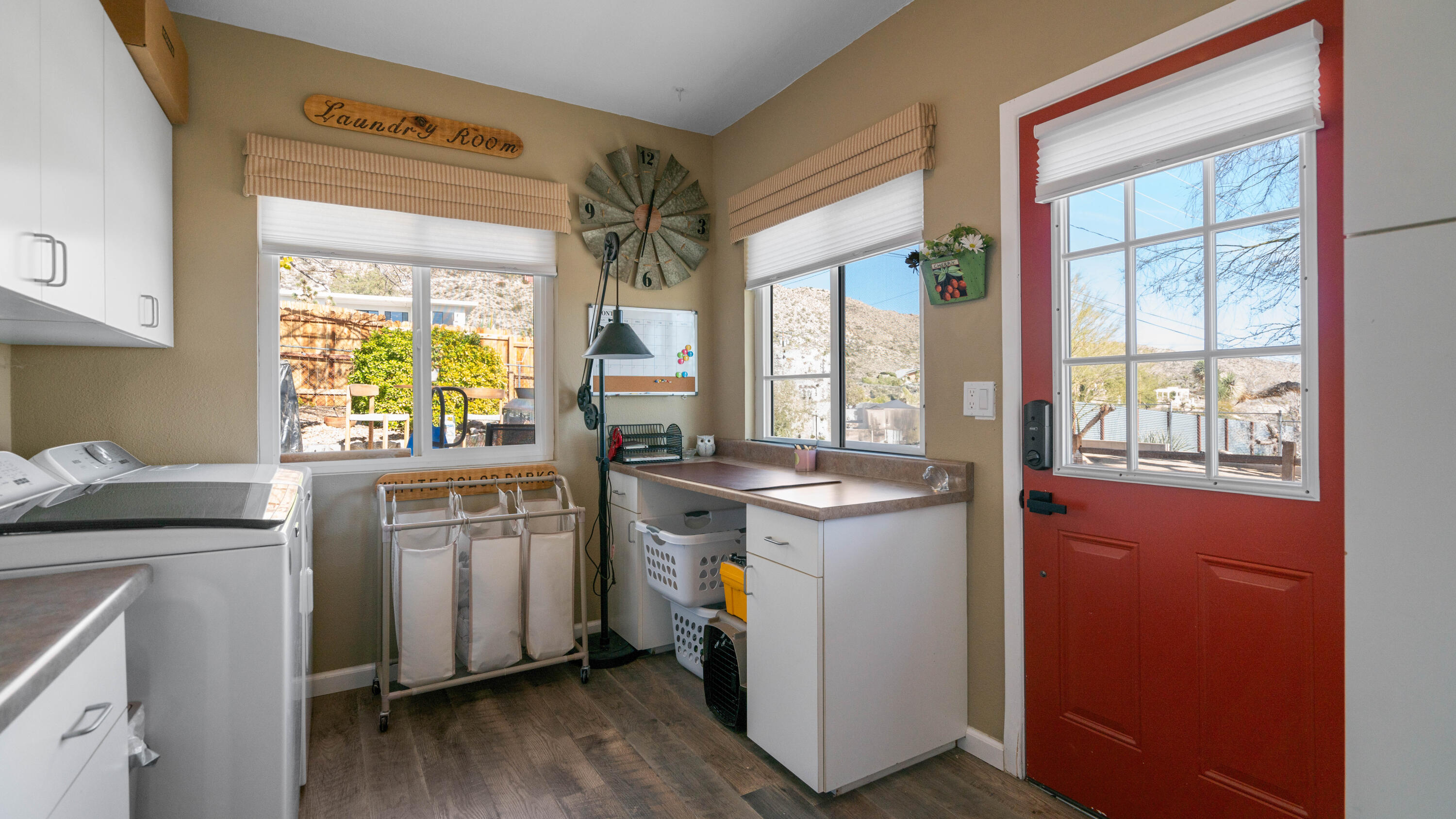 6913 Apache Trail Yucca Valley, CA 92284 - Photo 26 of 45 a kitchen with stainless steel appliances granite countertop a refrigerator a sink dishwasher a stove and white countertops with wooden floor