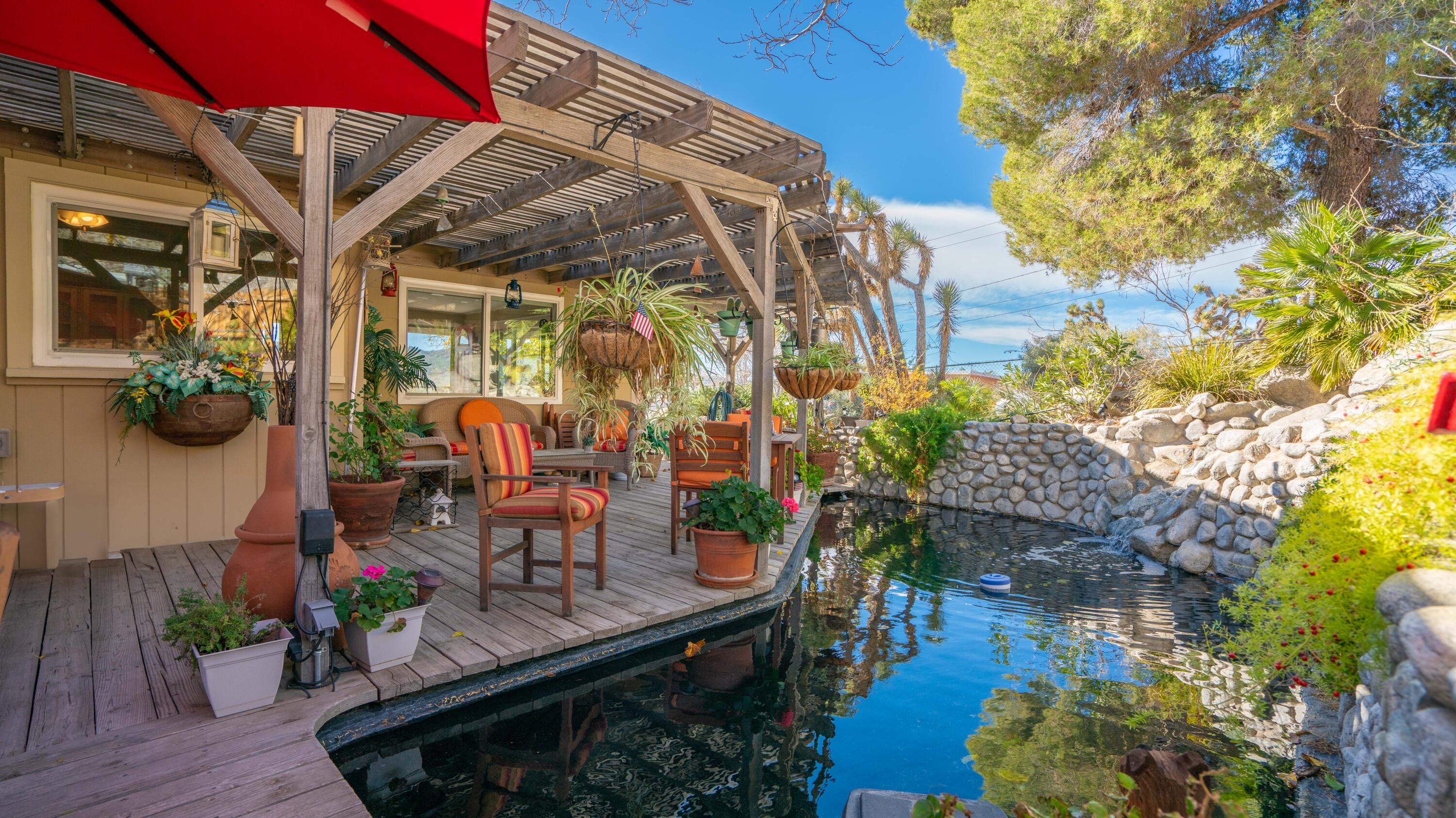6913 Apache Trail Yucca Valley, CA 92284 - Photo 28 of 45 a view of balcony with chairs and potted plants