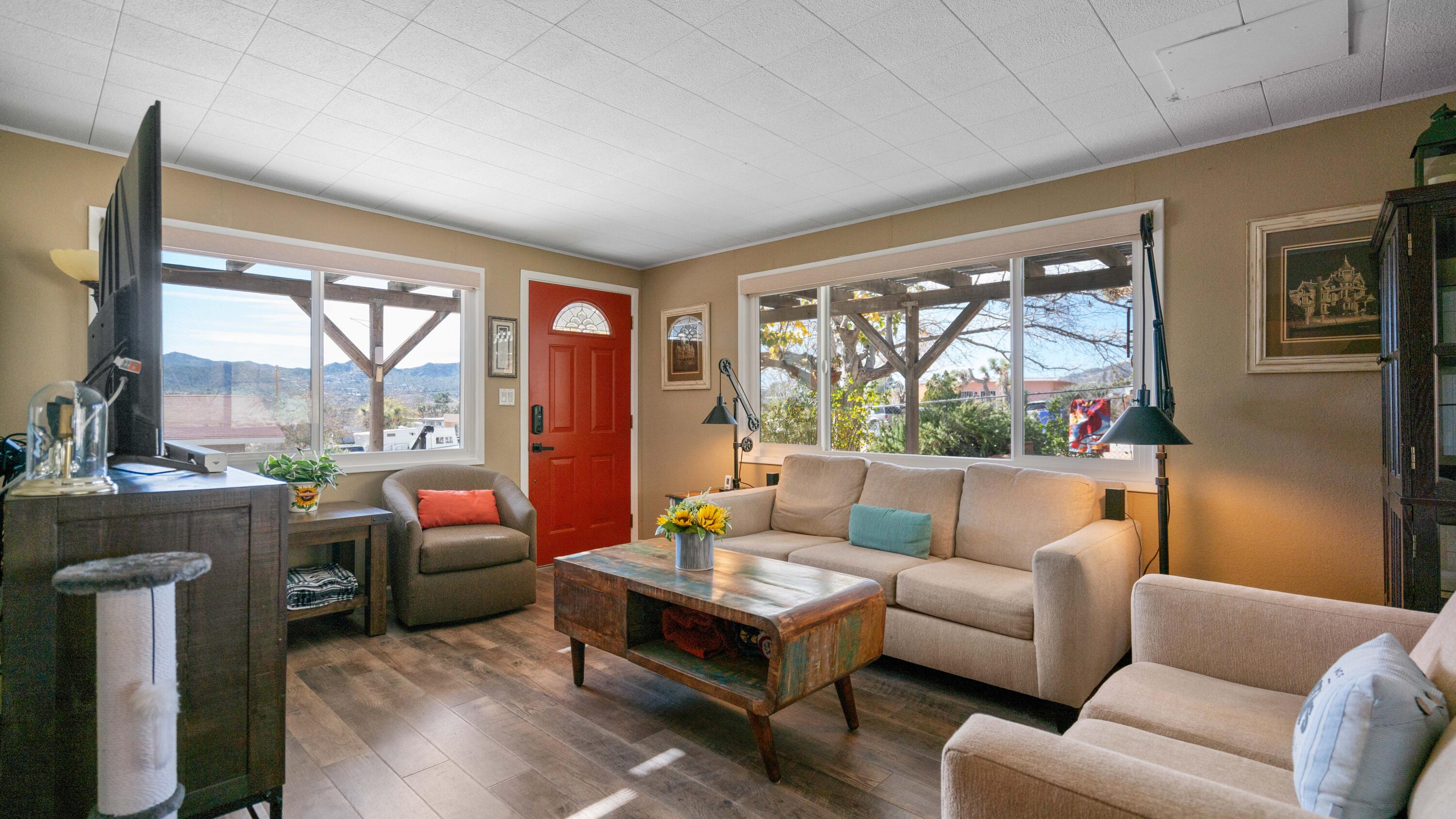 6913 Apache Trail Yucca Valley, CA 92284 - Photo 4 of 45 a living room with furniture and a large window
