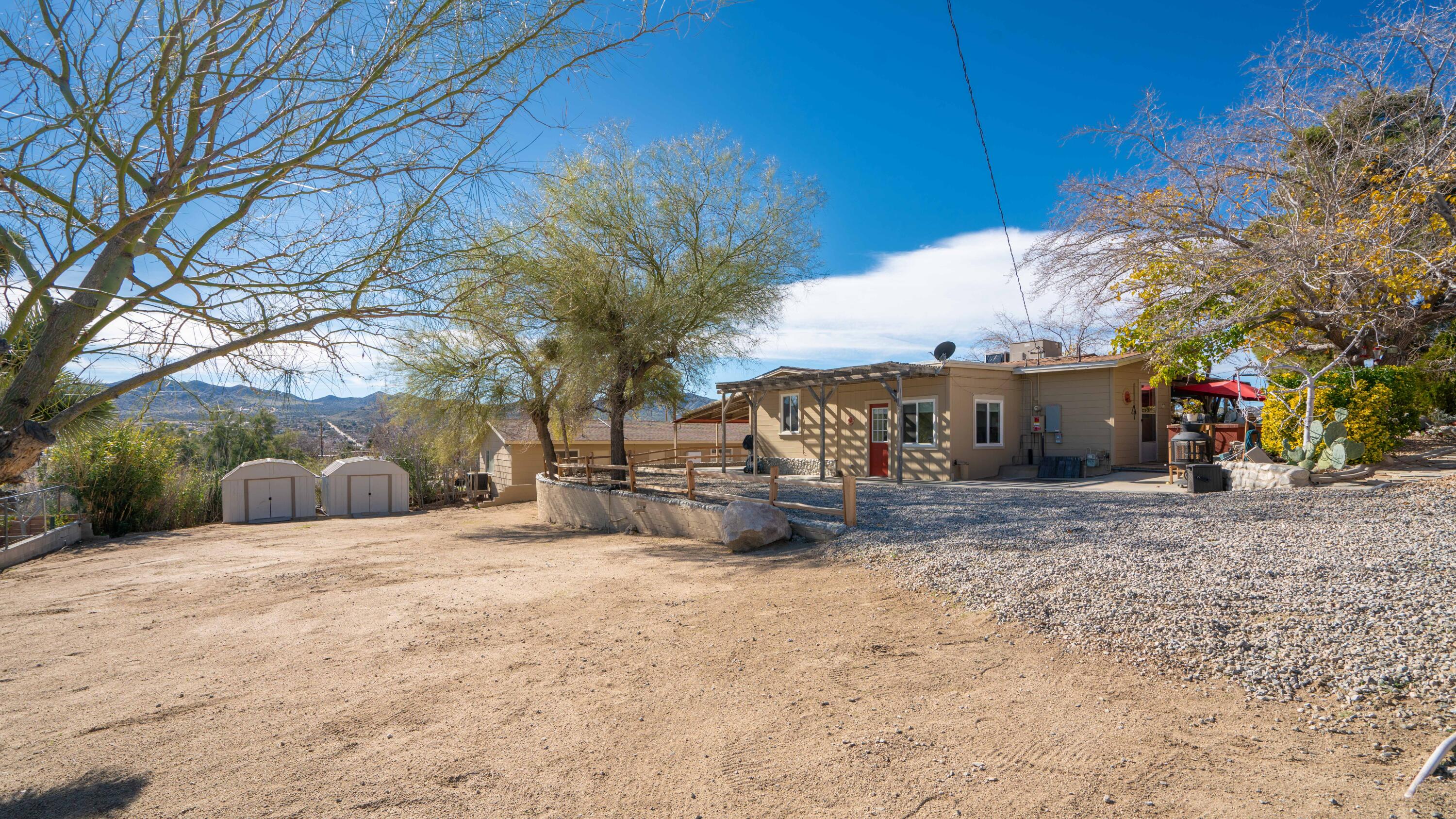 6913 Apache Trail Yucca Valley, CA 92284 - Photo 45 of 45 a view of a house with a yard and covered with snow