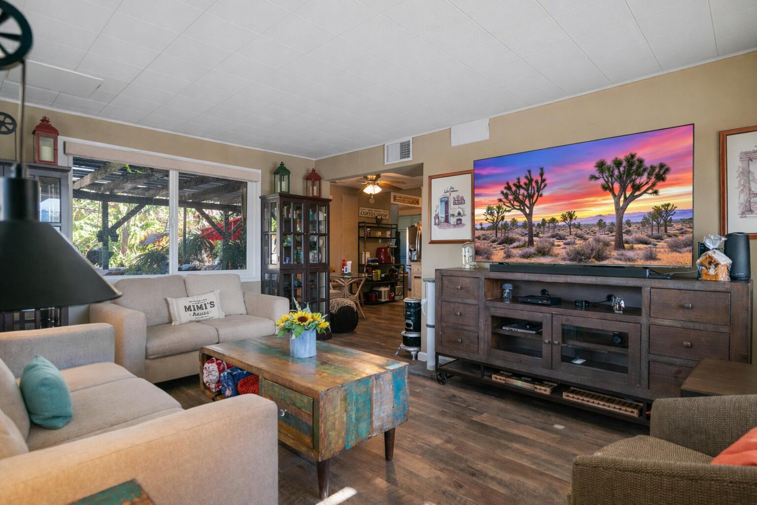 6913 Apache Trail Yucca Valley, CA 92284 - Photo 6 of 45 a living room with furniture and a flat screen tv