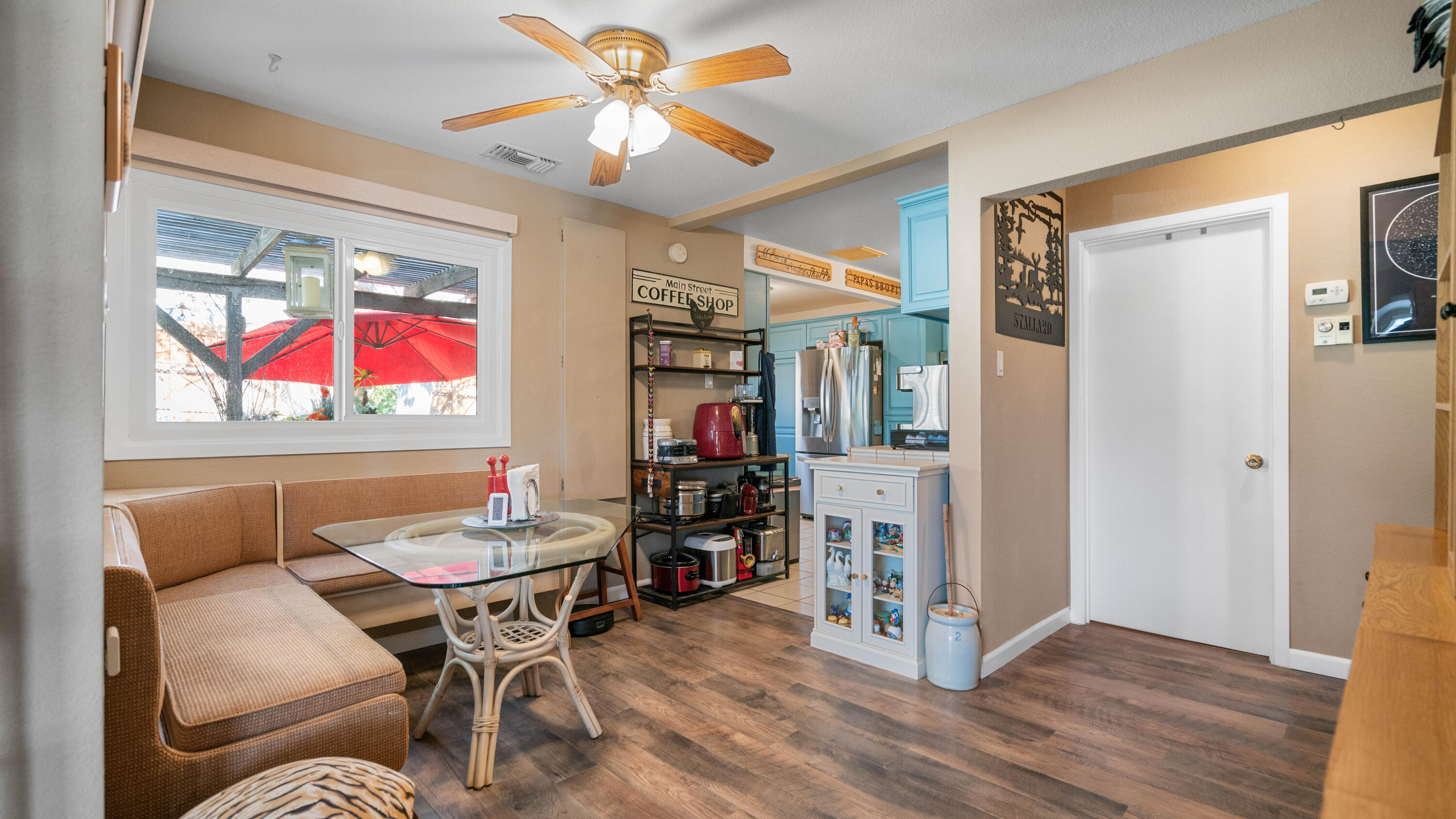 6913 Apache Trail Yucca Valley, CA 92284 - Photo 8 of 45 a dining room with furniture a chandelier and wooden floor