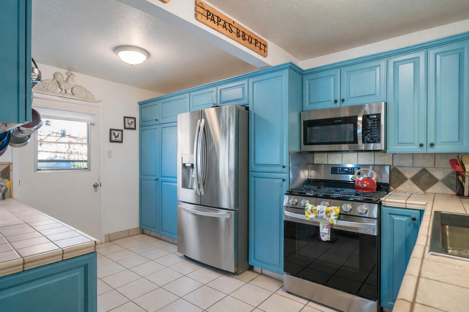 6913 Apache Trail Yucca Valley, CA 92284 - Photo 9 of 45 a kitchen with stainless steel appliances granite countertop a refrigerator stove and microwave