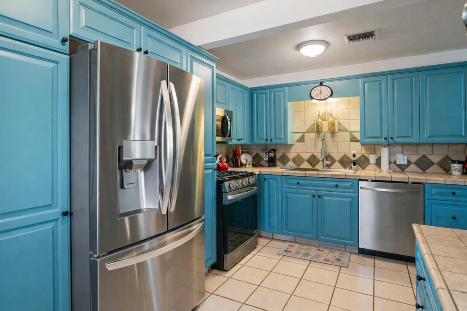 6913 Apache Trail Yucca Valley, CA 92284 - Photo 10 of 45 a kitchen with granite countertop stainless steel appliances and a refrigerator