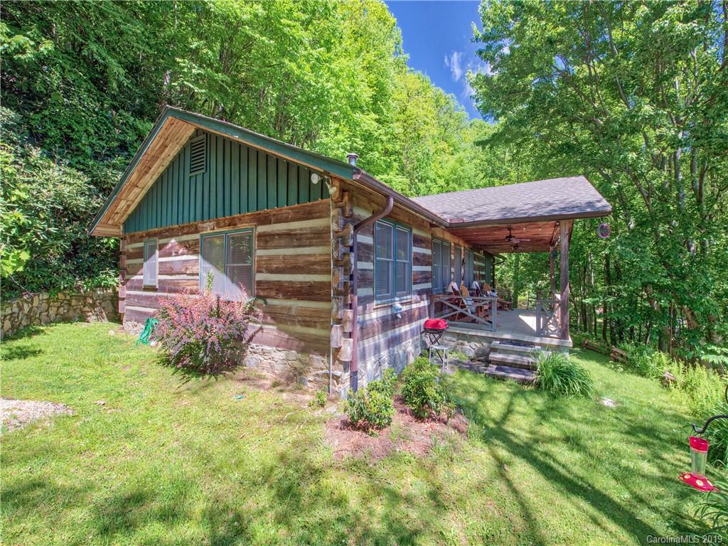 949 Setzercove Road Maggie Valley, NC 28751 - Photo 1 of 31 a backyard of a house with lots of green space