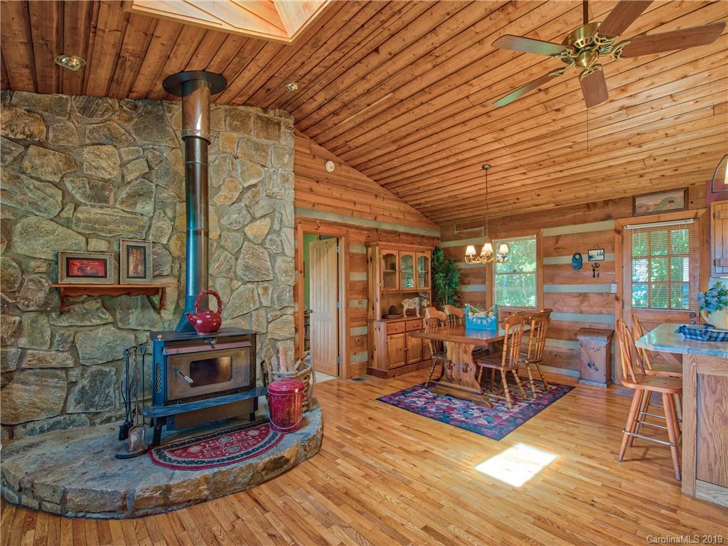949 Setzercove Road Maggie Valley, NC 28751 - Photo 15 of 31 a living room with fireplace furniture and wooden floor
