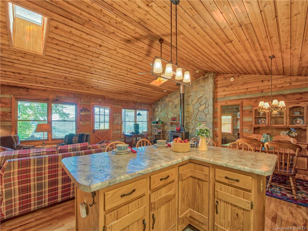 949 Setzercove Road Maggie Valley, NC 28751 - Photo 19 of 31 a kitchen with stainless steel appliances granite countertop a sink and wooden cabinets