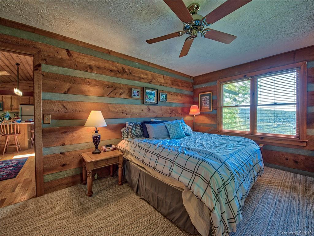 949 Setzercove Road Maggie Valley, NC 28751 - Photo 20 of 31 a bedroom with a bed and a window
