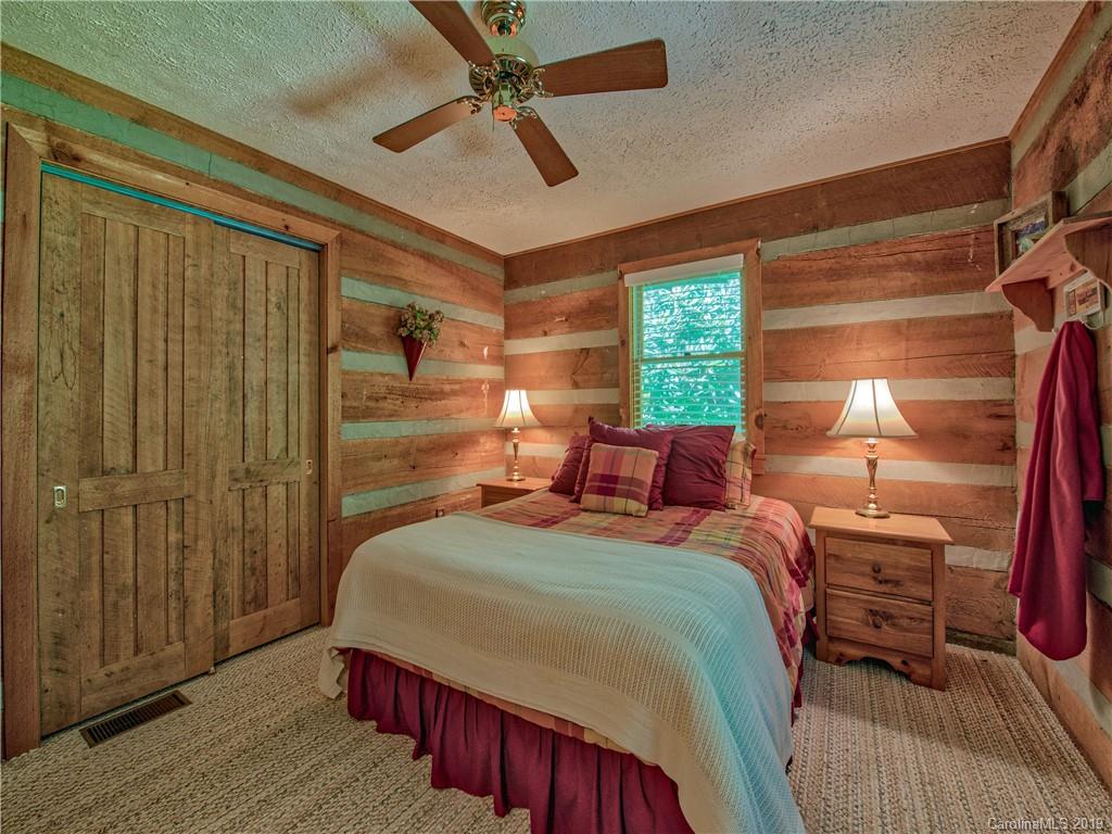 949 Setzercove Road Maggie Valley, NC 28751 - Photo 26 of 31 a bed room with a bed and a window