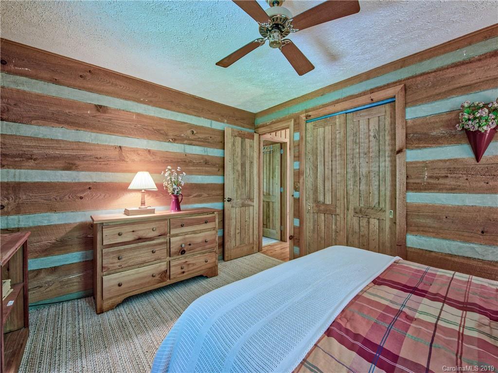 949 Setzercove Road Maggie Valley, NC 28751 - Photo 27 of 31 a bed room with a bed and a dresser