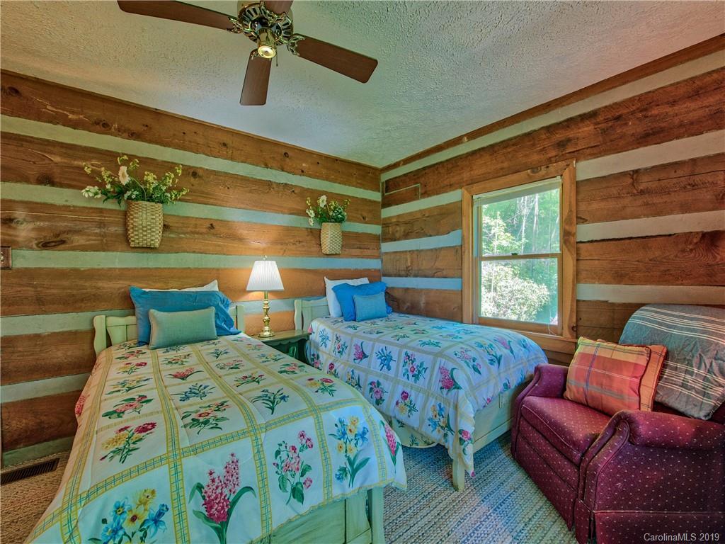 949 Setzercove Road Maggie Valley, NC 28751 - Photo 28 of 31 a bedroom with two beds and a window