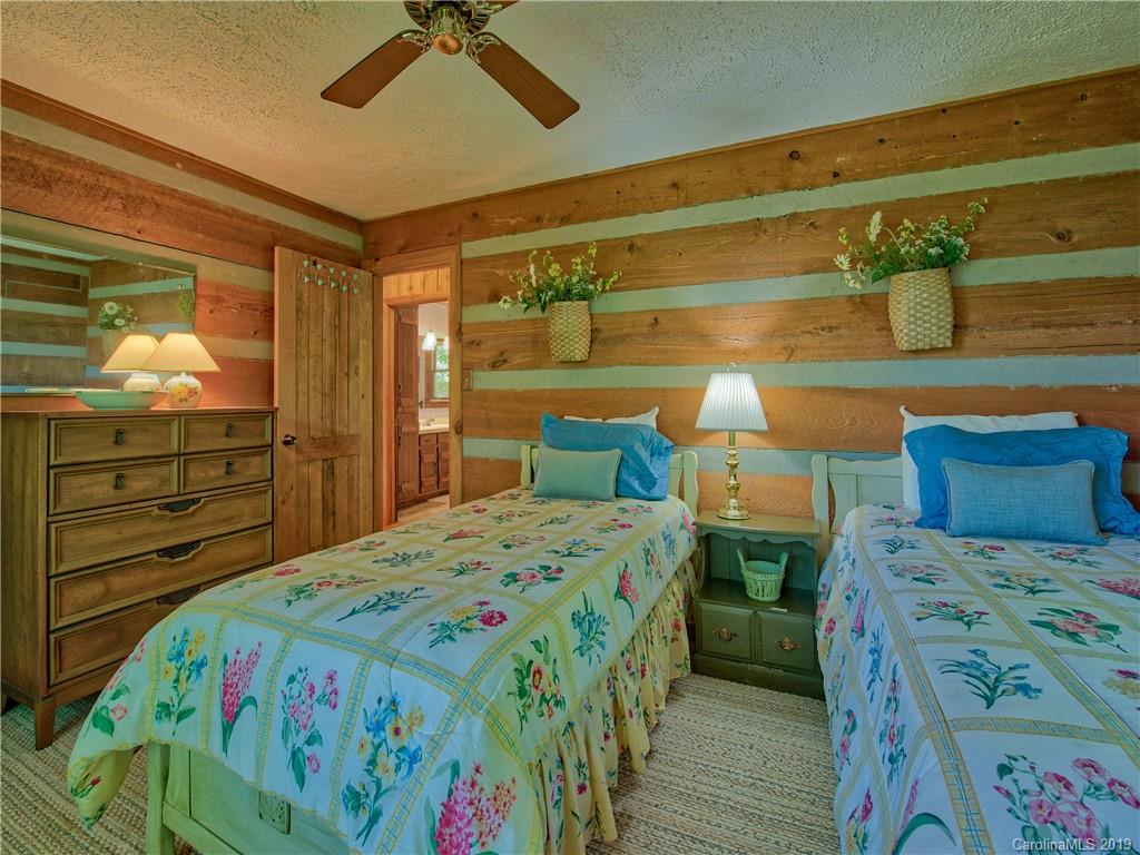 949 Setzercove Road Maggie Valley, NC 28751 - Photo 29 of 31 a bedroom with a bed and a dresser