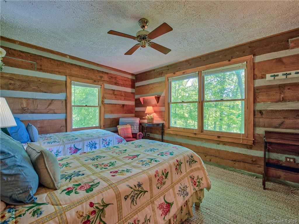 949 Setzercove Road Maggie Valley, NC 28751 - Photo 30 of 31 a bed sitting in a bedroom next to a window