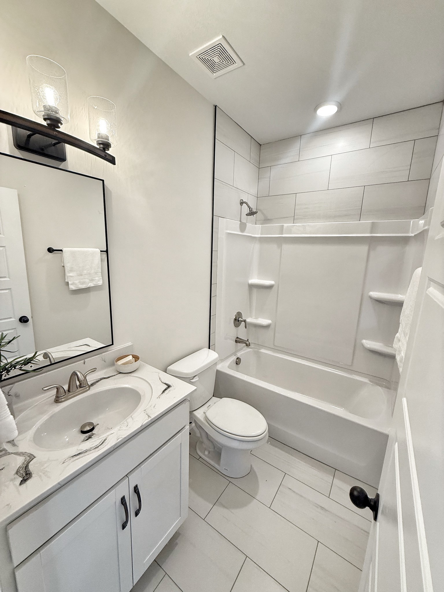 865 Burley Barn Road Clarksville, TN 37042 - Photo 29 of 44 a bathroom with a sink a toilet a mirror and bathtub