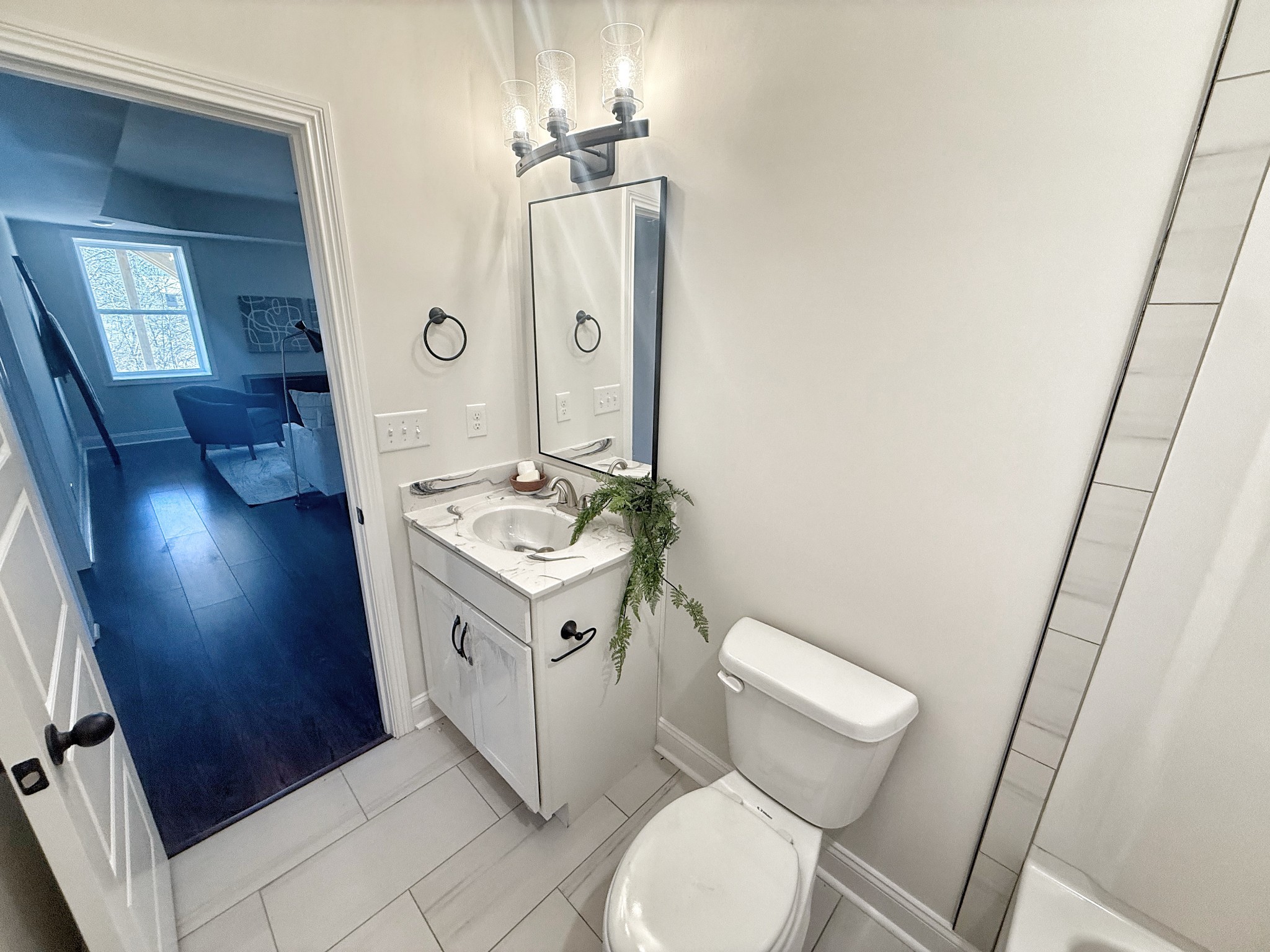 865 Burley Barn Road Clarksville, TN 37042 - Photo 35 of 44 a bathroom with a sink a toilet a mirror and vanity