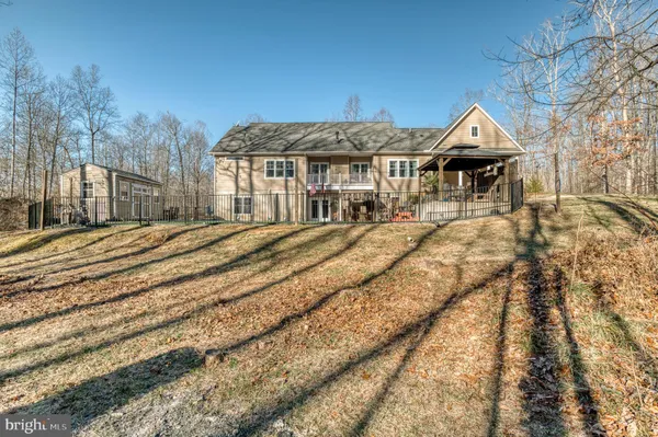 a view of a house with a wooden fence