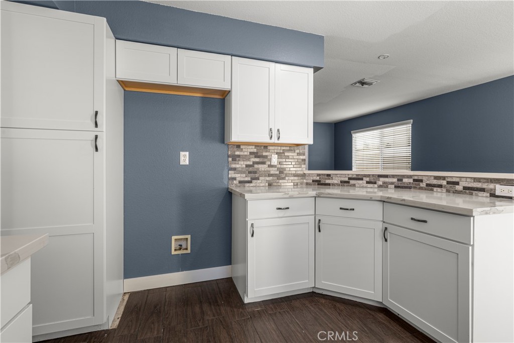 15417 Tobarra Road Fontana, CA 92337 - Photo 12 of 29 a kitchen with granite countertop white cabinets and white appliances