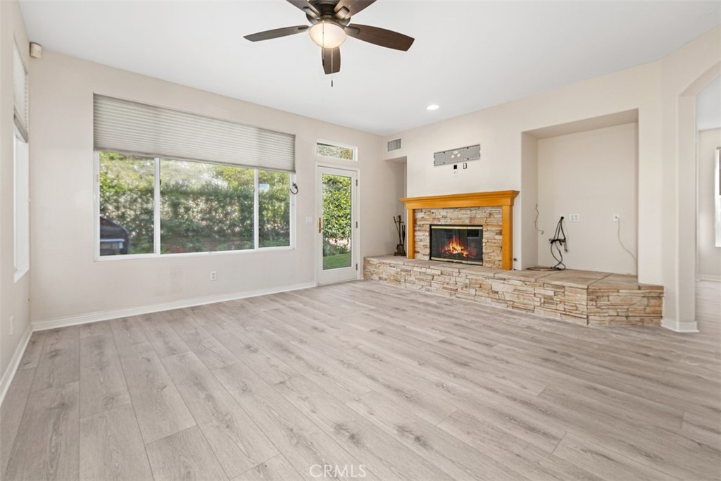 27806 Homestead Road Laguna Niguel, CA 92677 - Photo 11 of 52 a view of an empty room with wooden floor fireplace and a window