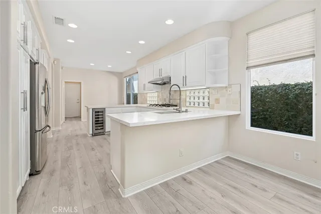 a kitchen with white cabinets and white stainless steel appliances