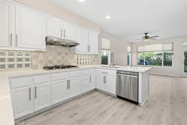 a kitchen with stainless steel appliances a white stove top oven and sink