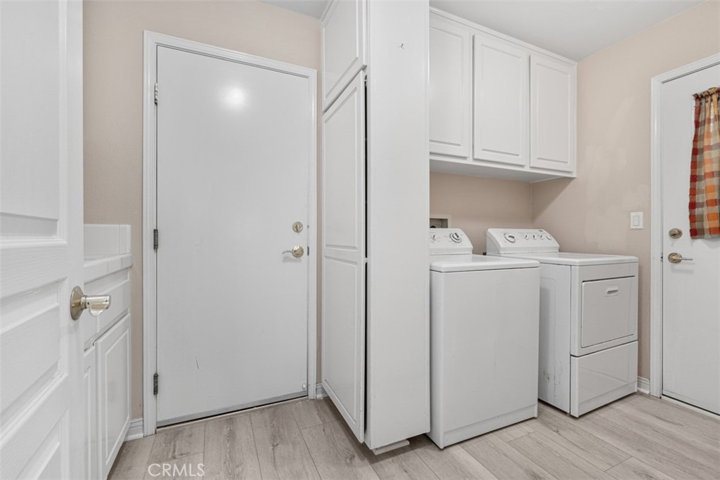 27806 Homestead Road Laguna Niguel, CA 92677 - Photo 19 of 52 a utility room with cabinets washer and dryer