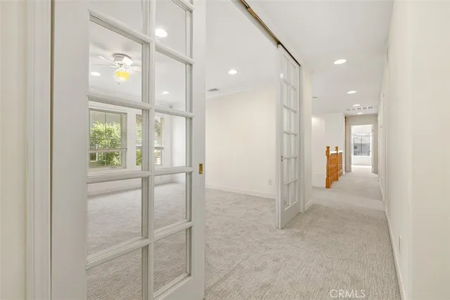 a large kitchen with stainless steel appliances a large counter top a stove and a refrigerator