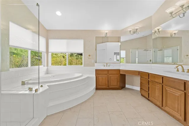 a bathroom with a tub shower and sink