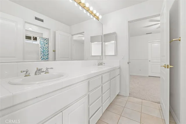 an empty room with closet and fan