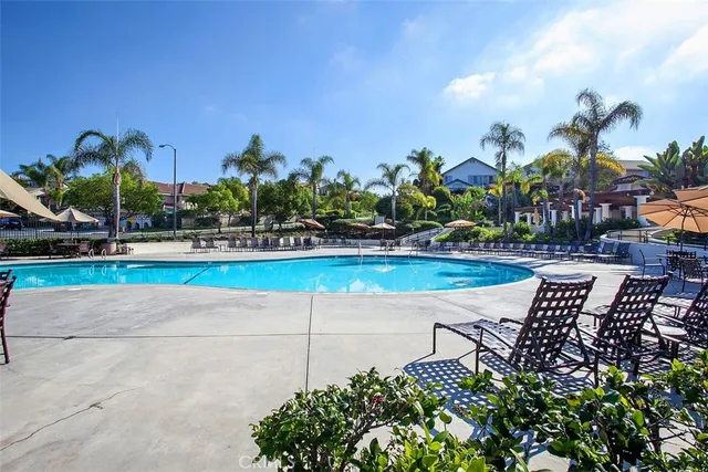 a view of patio with lawn chairs under an umbrella